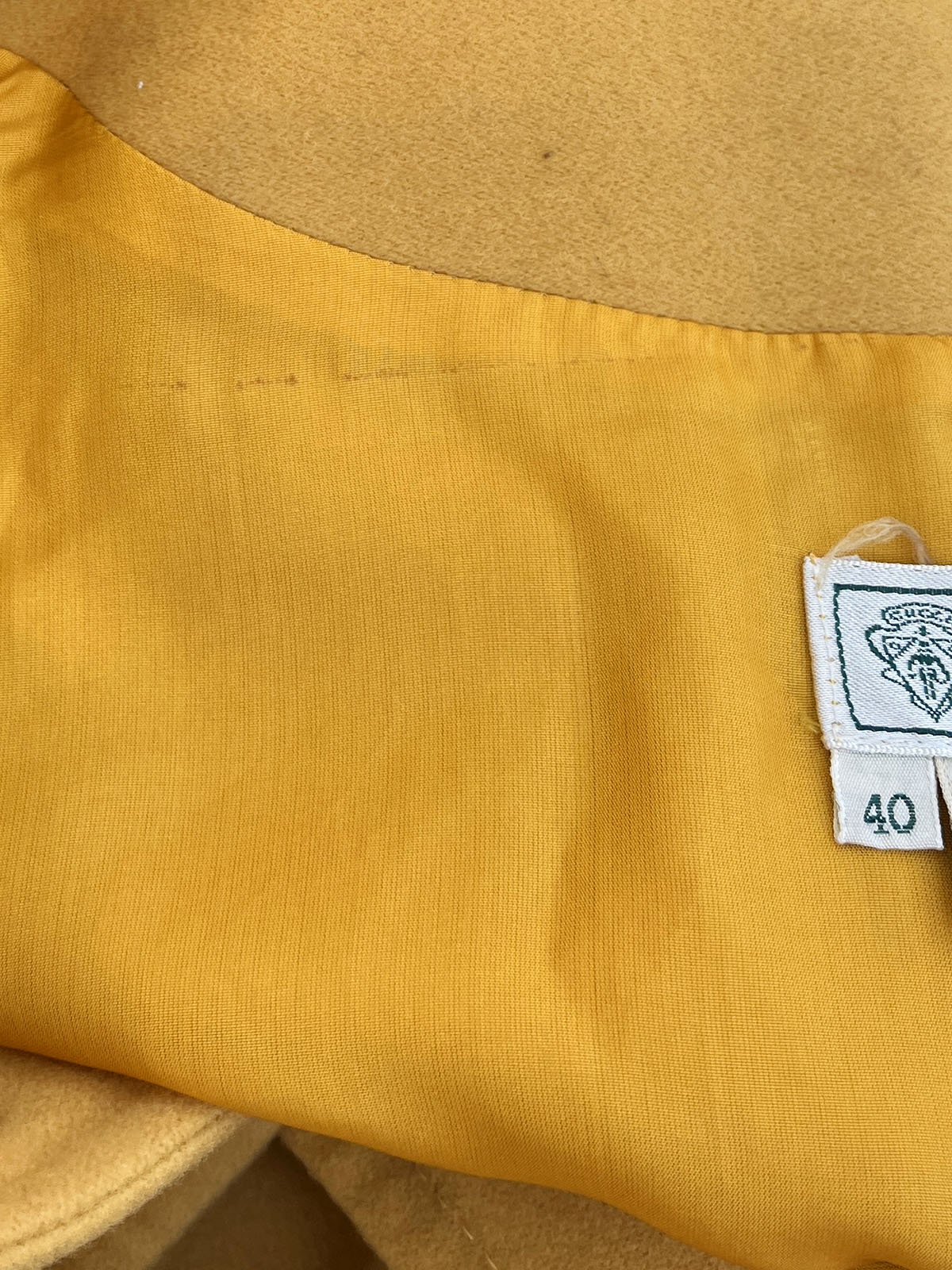 Wool collarless long coat in mustard yellow