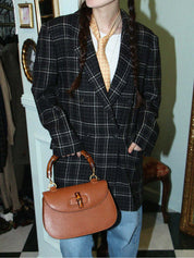Check pattern double-breasted jacket in charcoal gray, white, and black