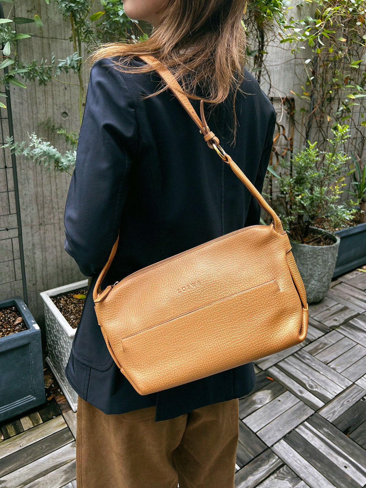 Logo embossed shoulder bag in beige
