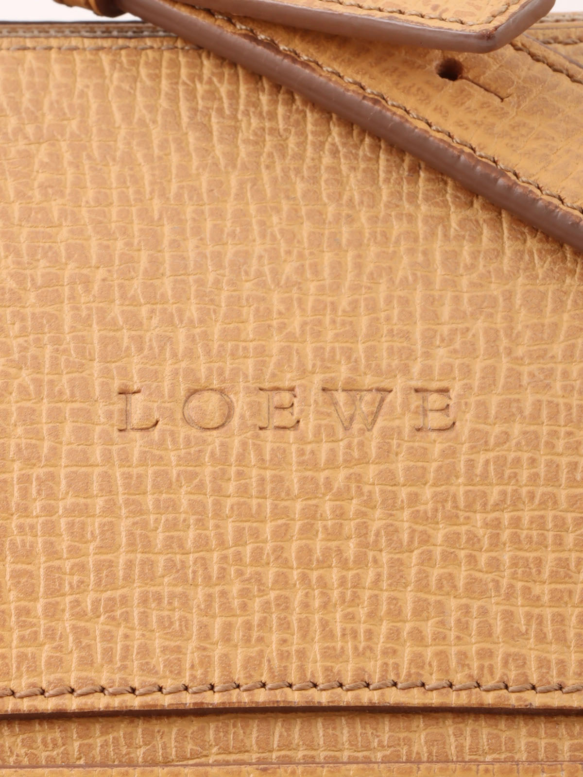 Logo embossed shoulder bag in beige