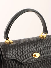 Logo plaque quilted handbag in black