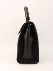 Logo plaque quilted handbag in black