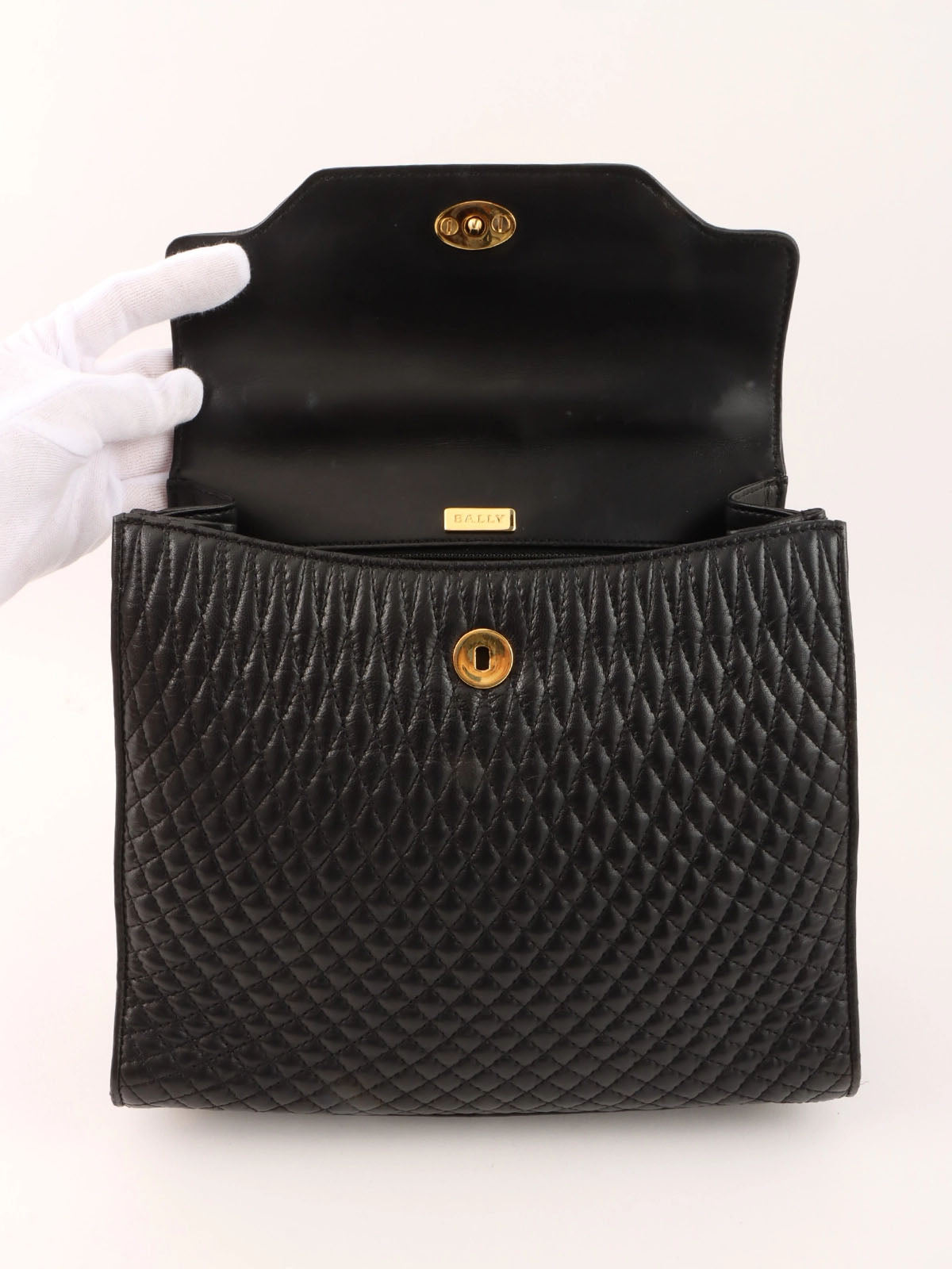 Logo plaque quilted handbag in black