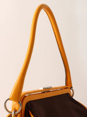Canvas and leather combination logo embossed clasp handbag in brown/yellow