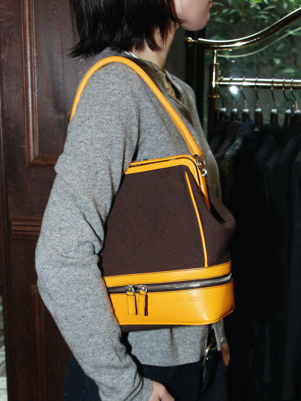 Canvas and leather combination logo embossed clasp handbag in brown/yellow