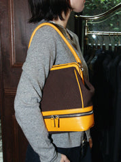Canvas and leather combination logo embossed clasp handbag in brown/yellow