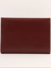 Logo embossed clutch bag in burgundy