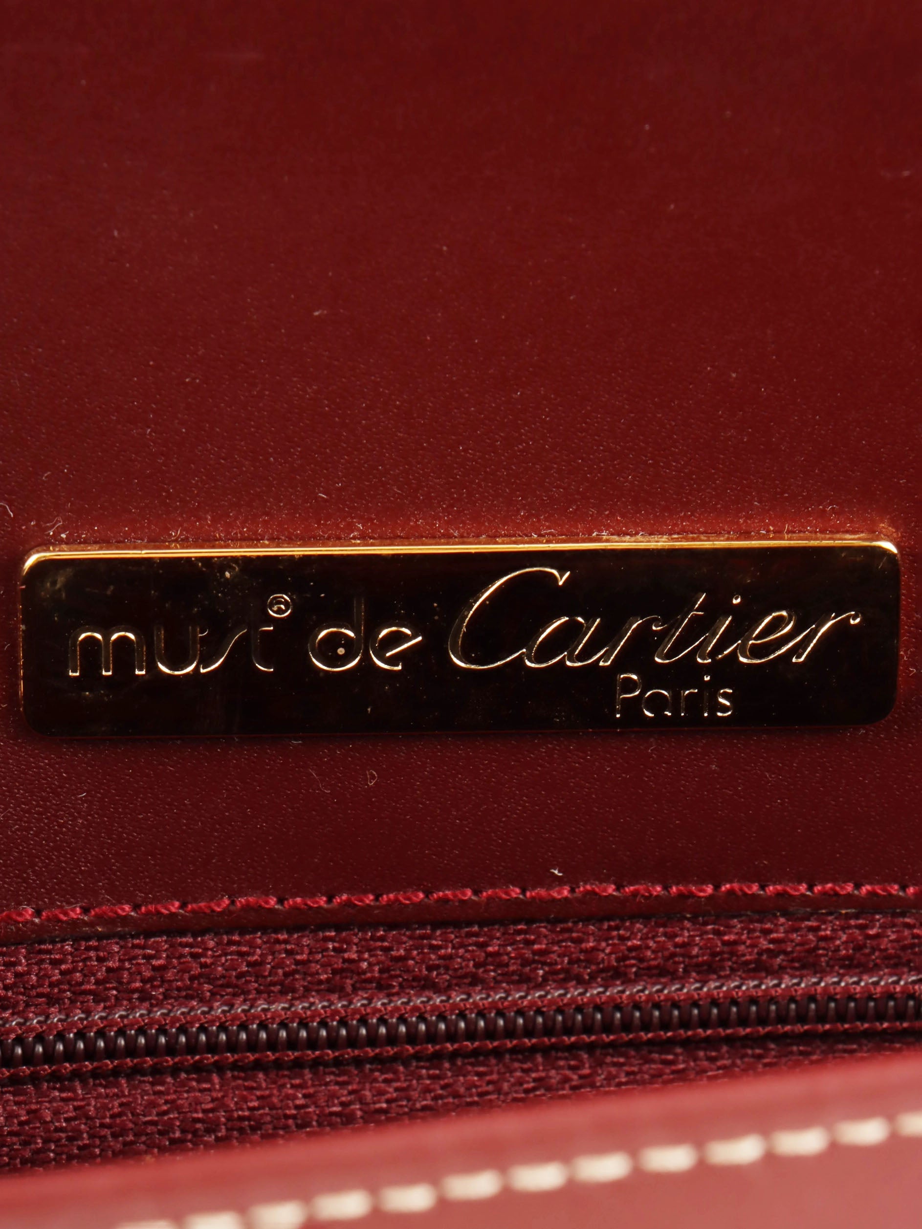 Logo embossed clutch bag in burgundy