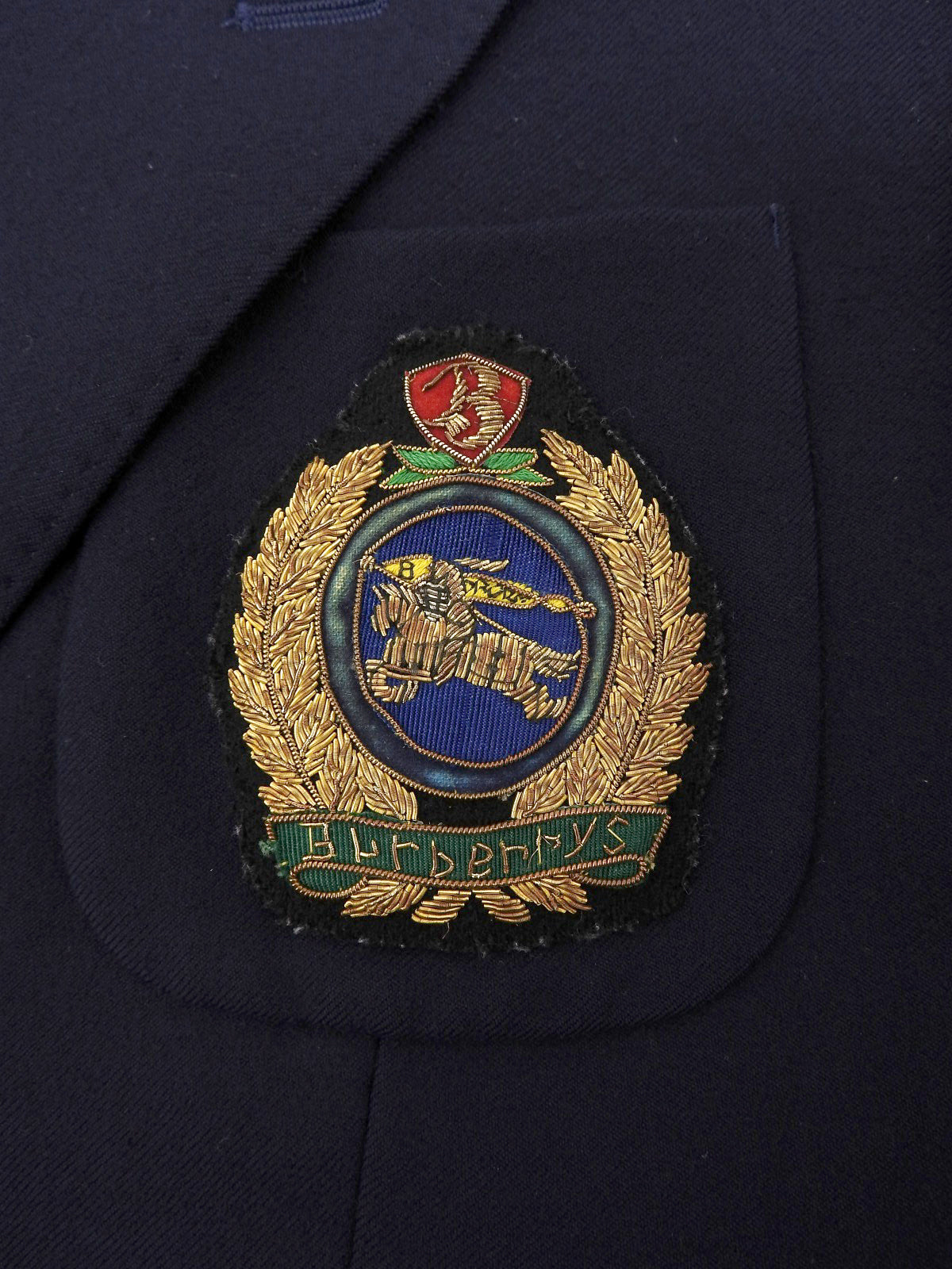 Navy double-breasted jacket with logo emblem patch
