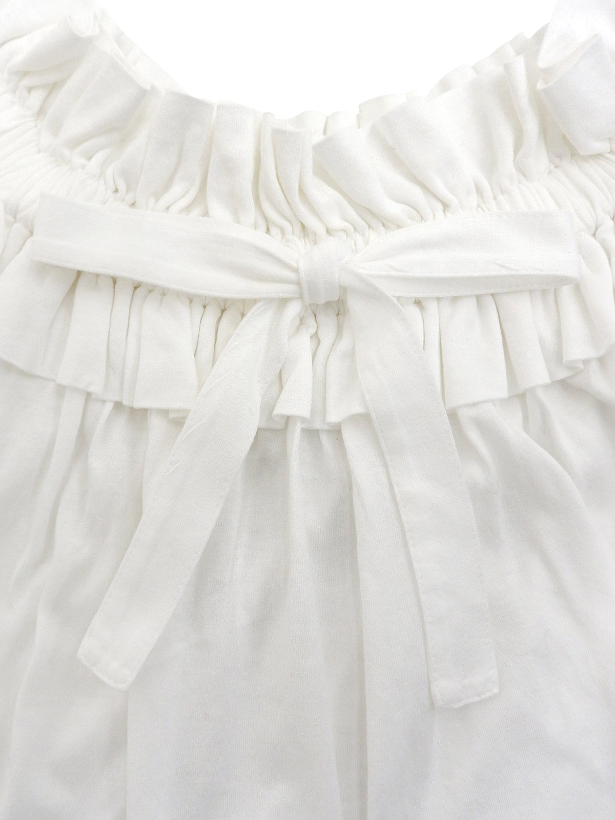 White ruffle sleeveless top